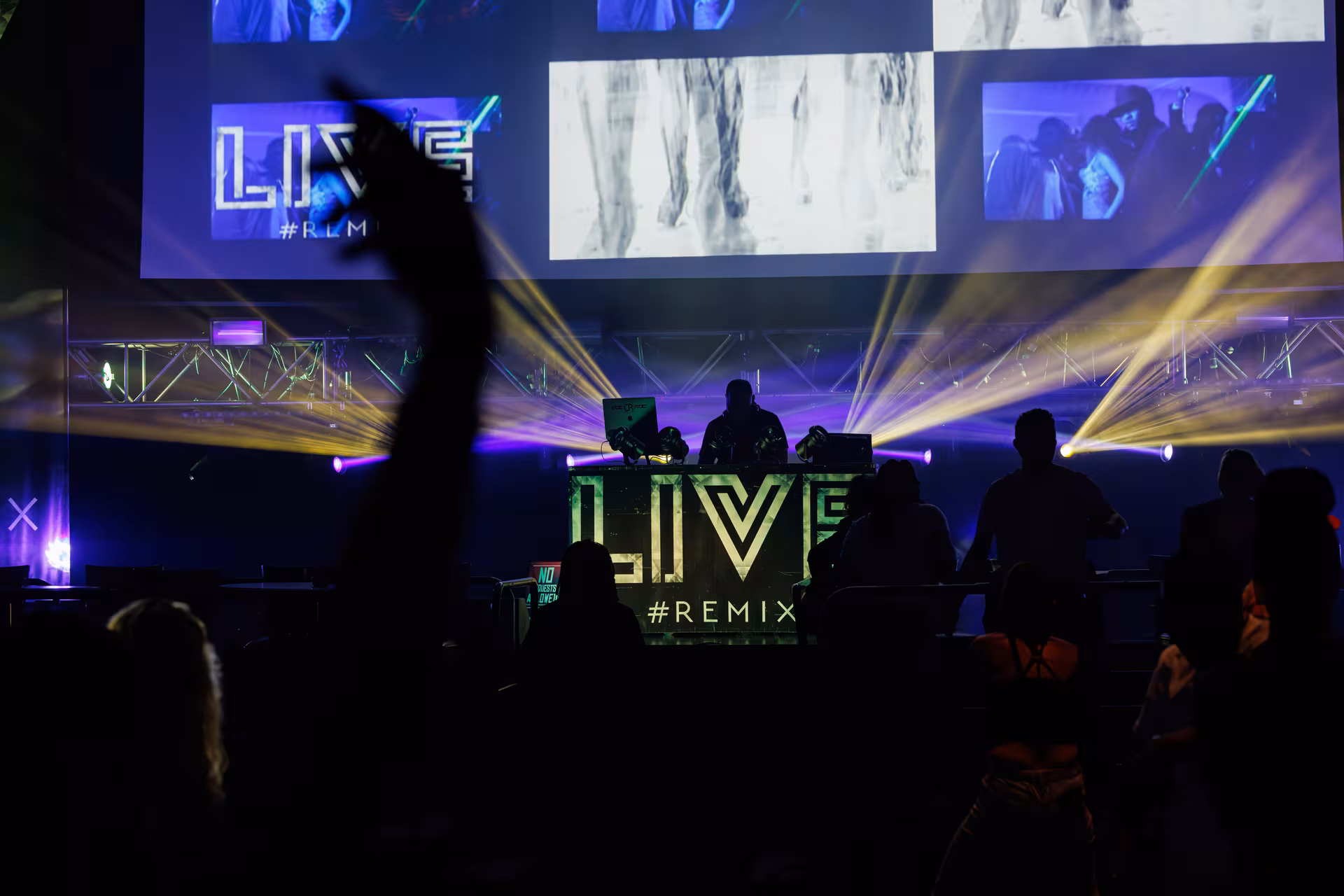 a group of people on a stage with a stage with a large screen